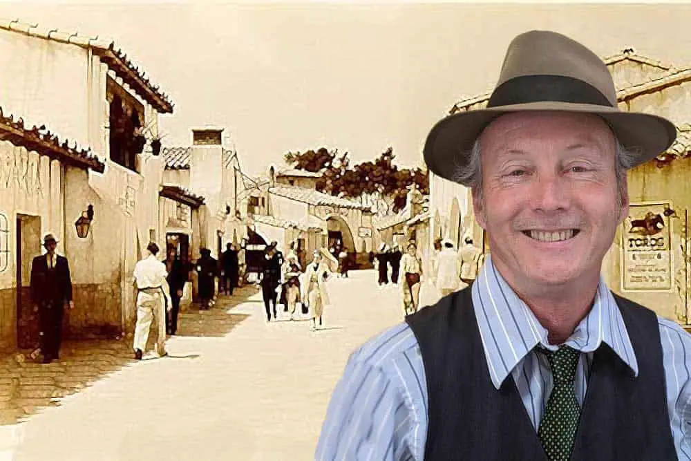 Spanish Village's historian and tour guide Jeffrey Iles in front of an 1940's photo of the Village.