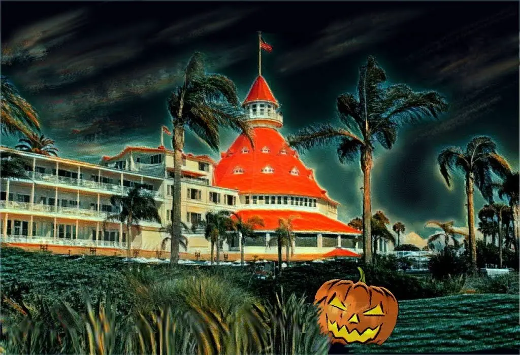 Hotel del Coronado at Halloween with a jack-o'-lantern in the foreground.
