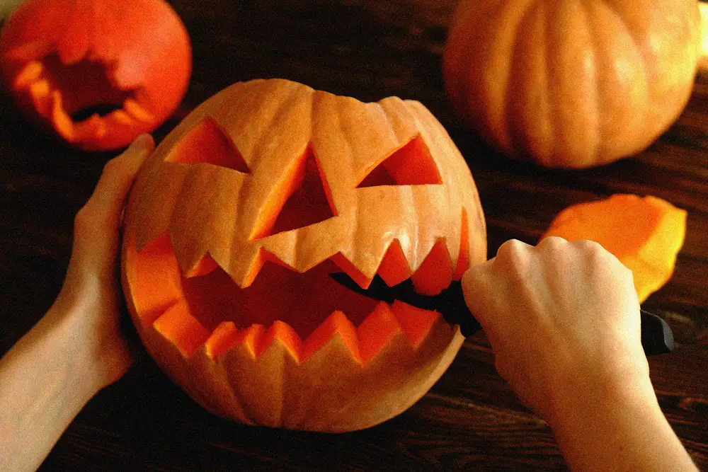 Close-up of woman carving pumpkin at the Hotel del Coronado