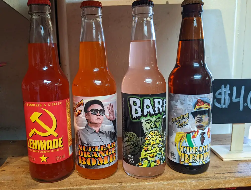 4 bottles of soda pop in Old Town Jerky & Root Beer. Left to right they are: "Leninade", "Nuclear Orange Bomb" (with Kim Jong Un on label), "Barf", and "Cream the People".