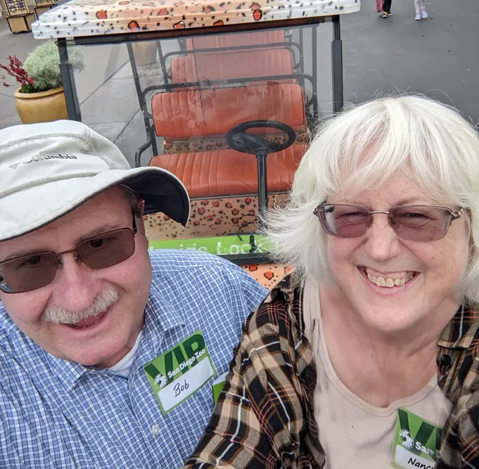 Bob and Nancy Ulrich taking a selfie in front of our Crazy About Cats Inside Look tour cart.